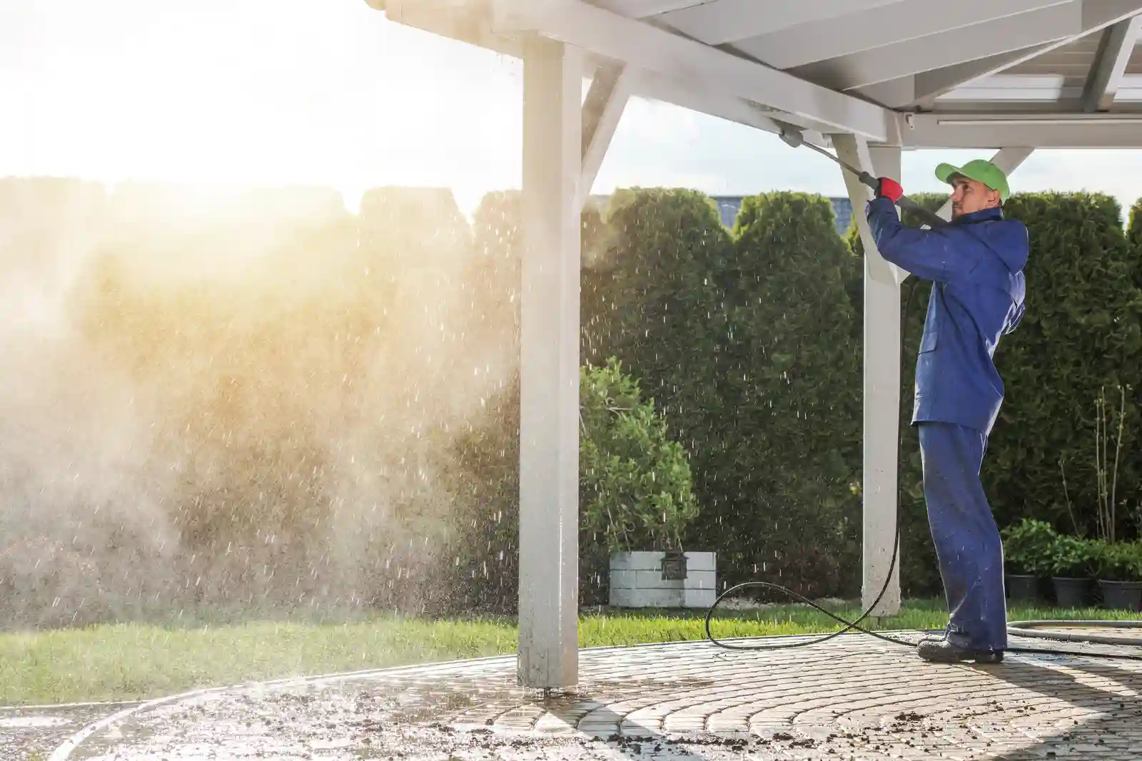 House Patio Roof Power Cleaning. Caucasian Worker with Pressure Washer.