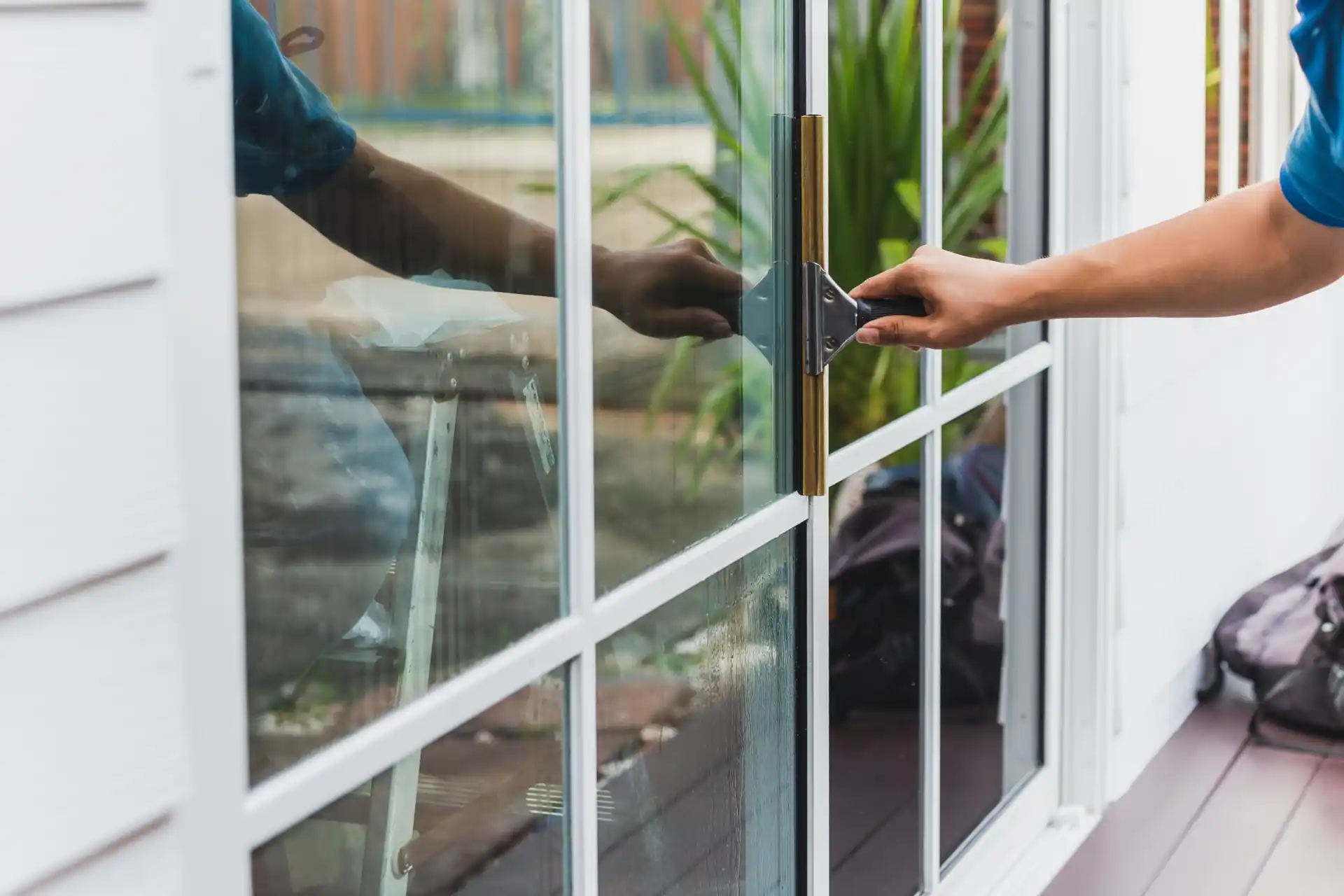 Drying a clean window with a squeegee